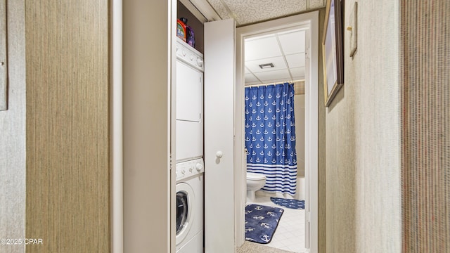 laundry area with stacked washer / drying machine