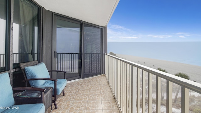 balcony with a view of the beach and a water view