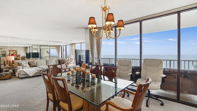 carpeted dining room with a textured ceiling, a chandelier, and a wealth of natural light