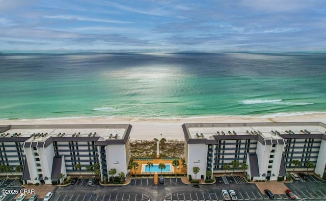 birds eye view of property with a beach view and a water view