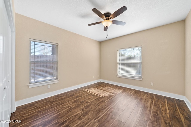 spare room featuring a ceiling fan, a textured ceiling, baseboards, and wood finished floors