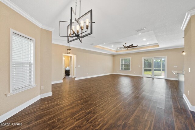 unfurnished living room with dark wood-style floors, a tray ceiling, and crown molding