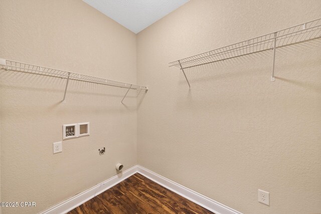 clothes washing area featuring hookup for a washing machine, dark wood-type flooring, electric dryer hookup, laundry area, and baseboards