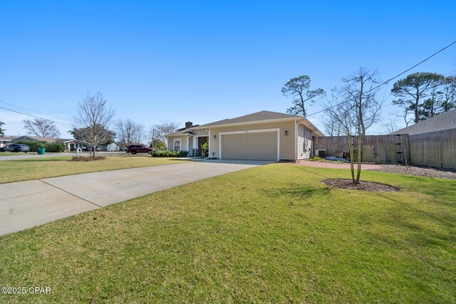 view of front of house with driveway, an attached garage, fence, and a front lawn