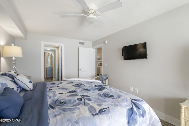 bedroom with ceiling fan, ensuite bath, visible vents, and baseboards