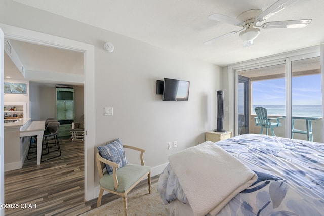 bedroom featuring a ceiling fan, baseboards, and wood finished floors