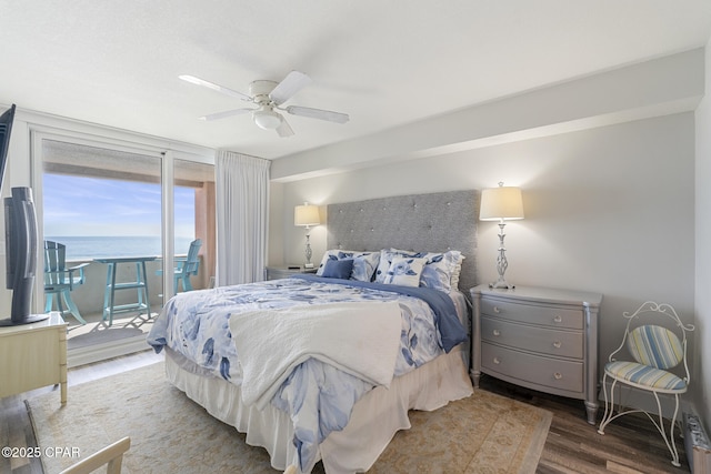 bedroom featuring access to outside, wood finished floors, and a ceiling fan