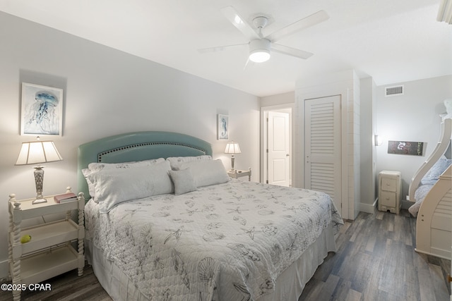 bedroom with a ceiling fan, a closet, visible vents, and wood finished floors