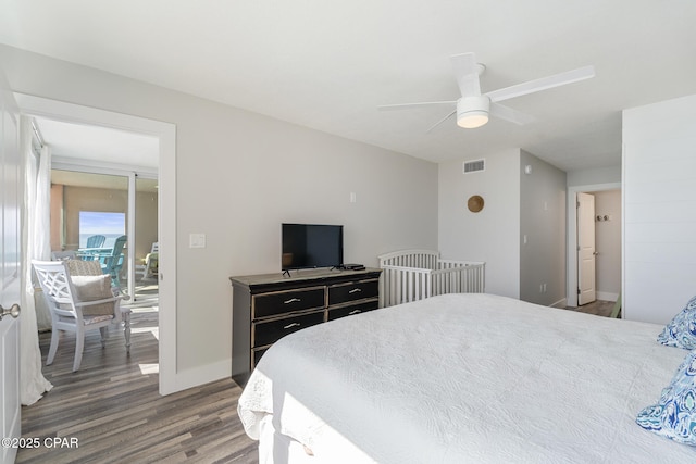 bedroom featuring a ceiling fan, baseboards, visible vents, and wood finished floors