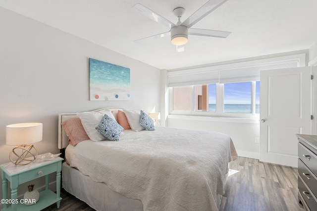 bedroom featuring a ceiling fan and wood finished floors