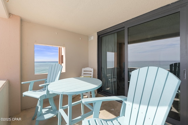 balcony with a sunroom and outdoor dining area