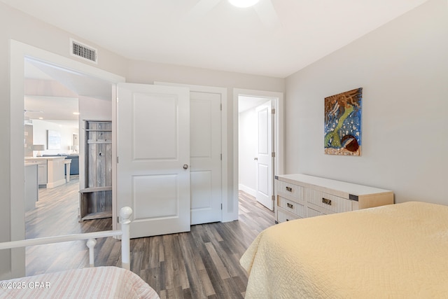 bedroom with a closet, visible vents, and wood finished floors