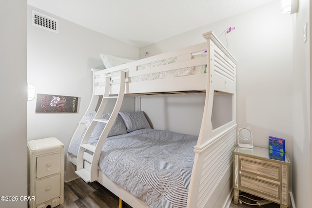 bedroom with visible vents and wood finished floors