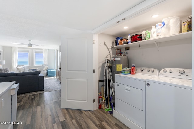 laundry room featuring laundry area, dark wood-type flooring, washer and clothes dryer, and a ceiling fan