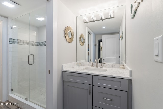 bathroom with a stall shower and vanity