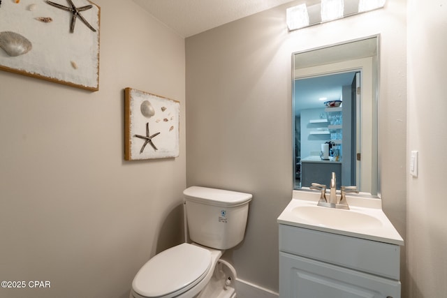 half bath with vanity and toilet