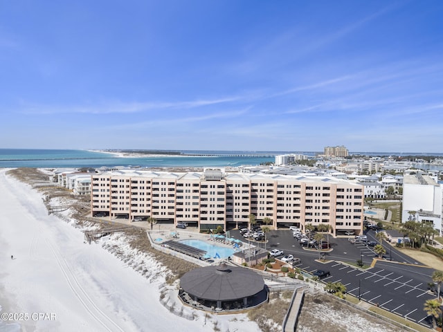 aerial view with a water view and a beach view