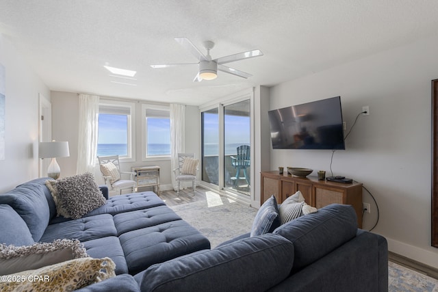 living area featuring a textured ceiling and wood finished floors