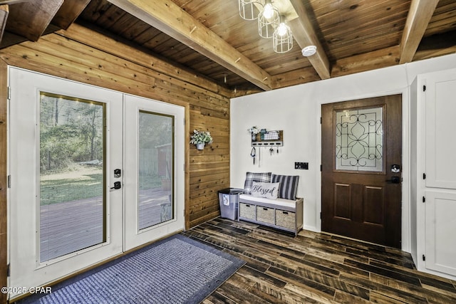 entryway featuring dark wood-style floors, french doors, wood walls, wooden ceiling, and beamed ceiling