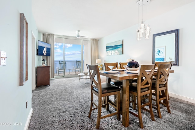 dining room with carpet flooring, floor to ceiling windows, and baseboards