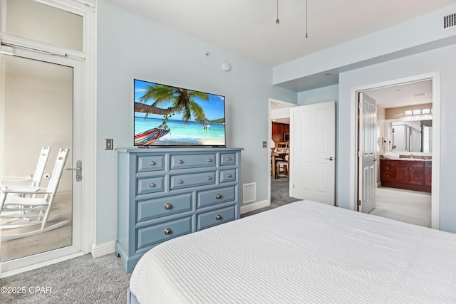 bedroom featuring connected bathroom, baseboards, visible vents, and light carpet