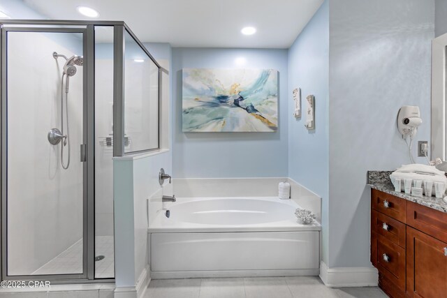 full bath with tile patterned floors, a garden tub, a shower stall, baseboards, and vanity