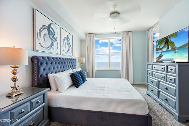 carpeted bedroom with baseboards and ceiling fan