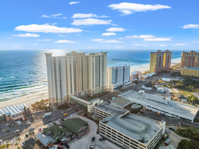 bird's eye view featuring a water view, a city view, and a beach view