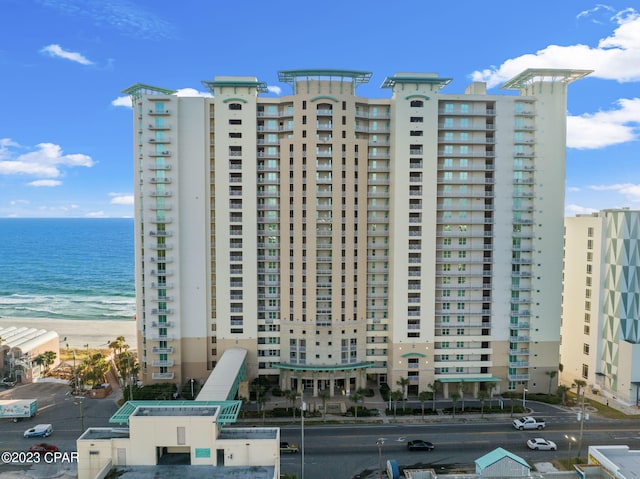 view of property with a beach view and a water view