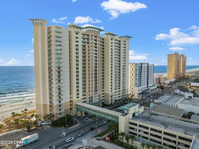 view of building exterior featuring a city view and a water view