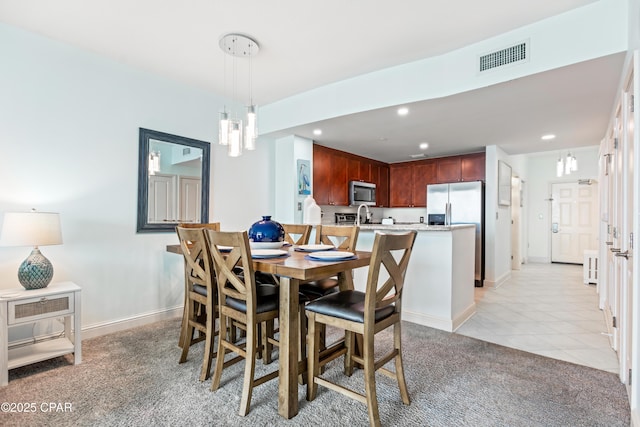 dining room with visible vents, recessed lighting, light tile patterned floors, baseboards, and light colored carpet