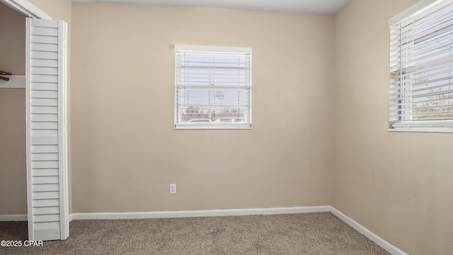 unfurnished bedroom featuring baseboards, a closet, and carpet floors