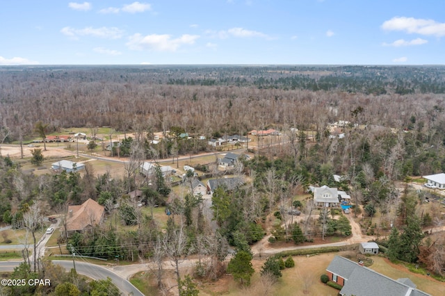 drone / aerial view with a residential view and a wooded view