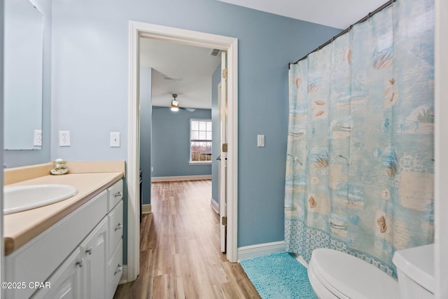 full bathroom featuring visible vents, baseboards, toilet, wood finished floors, and vanity