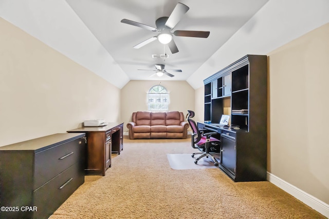 home office with lofted ceiling, light colored carpet, visible vents, a ceiling fan, and baseboards