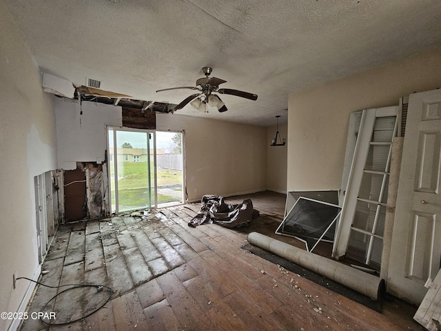 unfurnished living room with a textured ceiling, light wood-style flooring, visible vents, and a ceiling fan