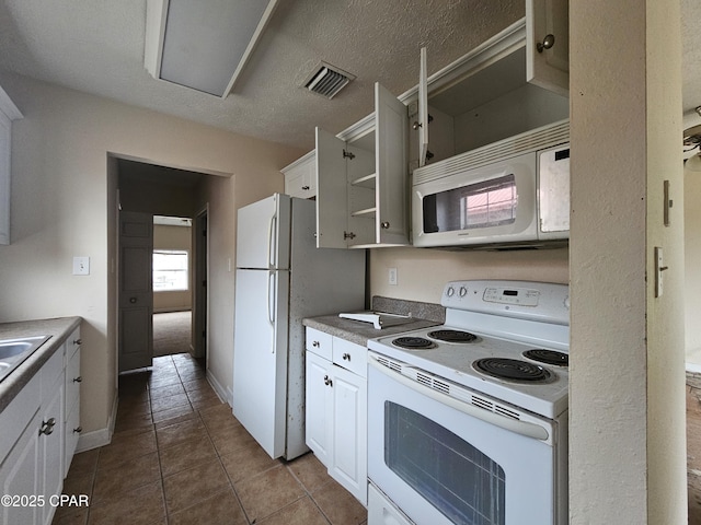 kitchen with white appliances, light tile patterned floors, visible vents, white cabinetry, and open shelves