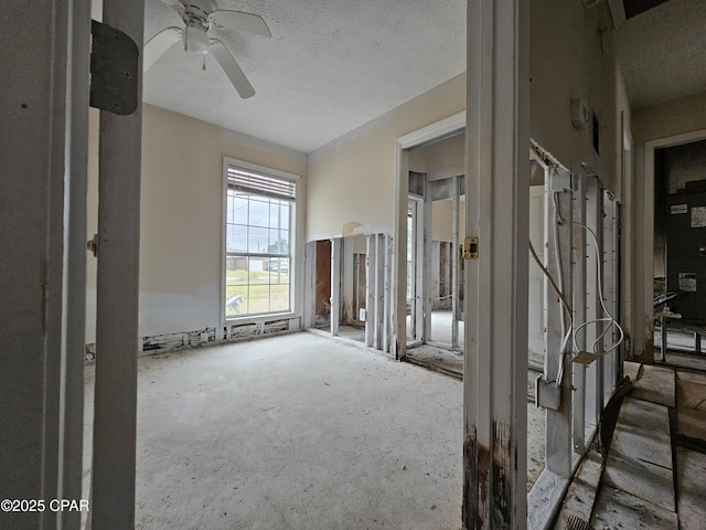 empty room featuring ceiling fan and a textured ceiling