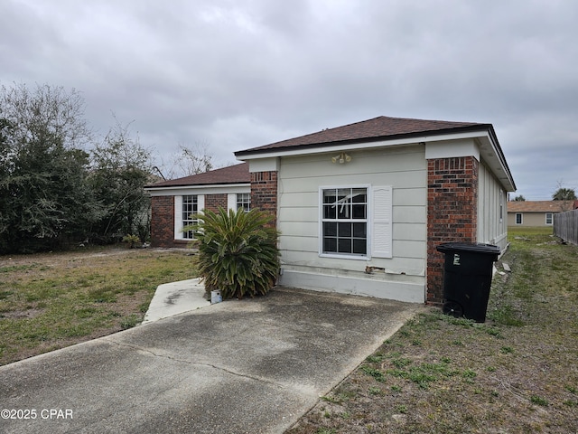 view of home's exterior featuring a lawn and brick siding