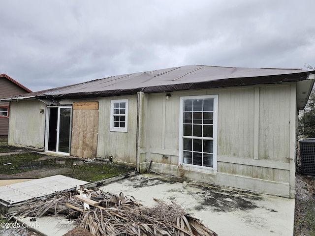 rear view of house with a patio area and central AC unit