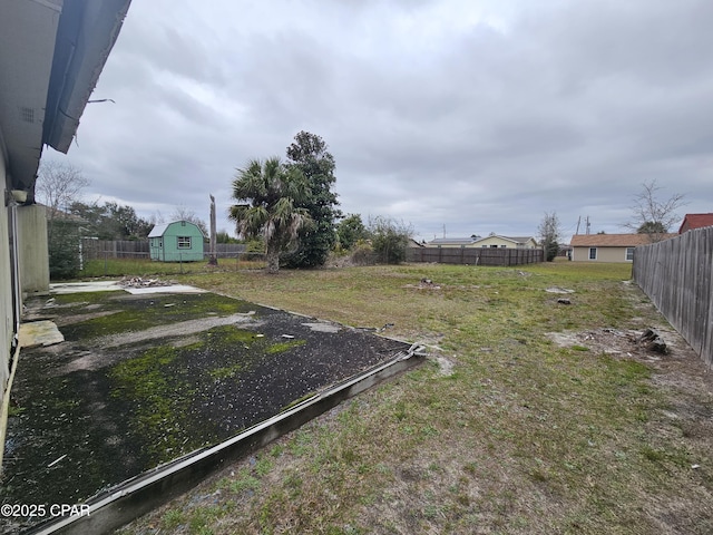 view of yard with an outbuilding and a fenced backyard