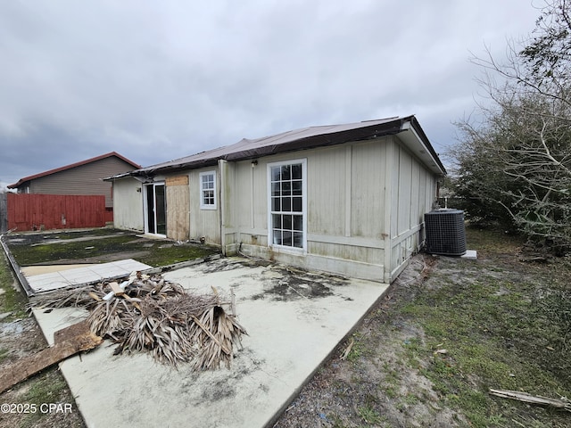 rear view of property with a patio area, fence, and cooling unit