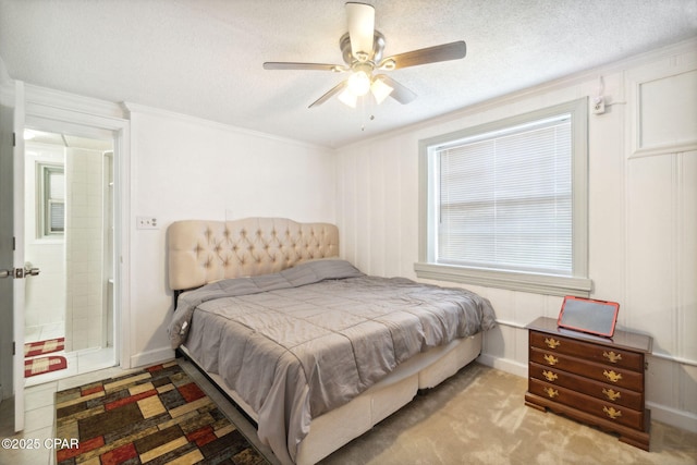 bedroom featuring crown molding, a ceiling fan, baseboards, and a textured ceiling