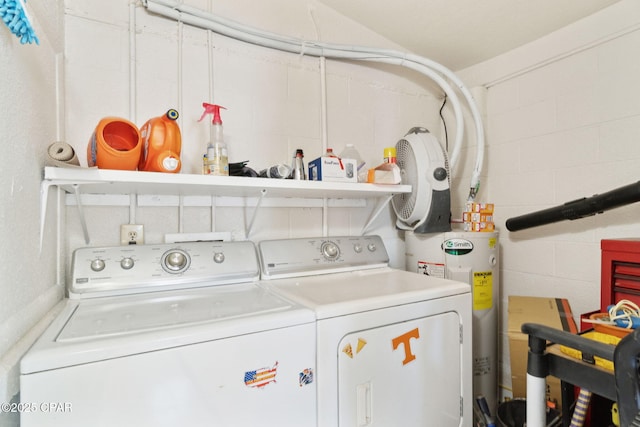 washroom with laundry area, concrete block wall, electric water heater, and washing machine and clothes dryer