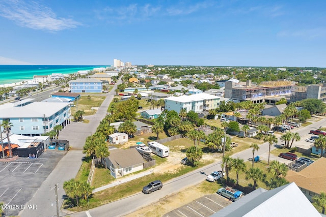 aerial view with a water view and a view of the beach