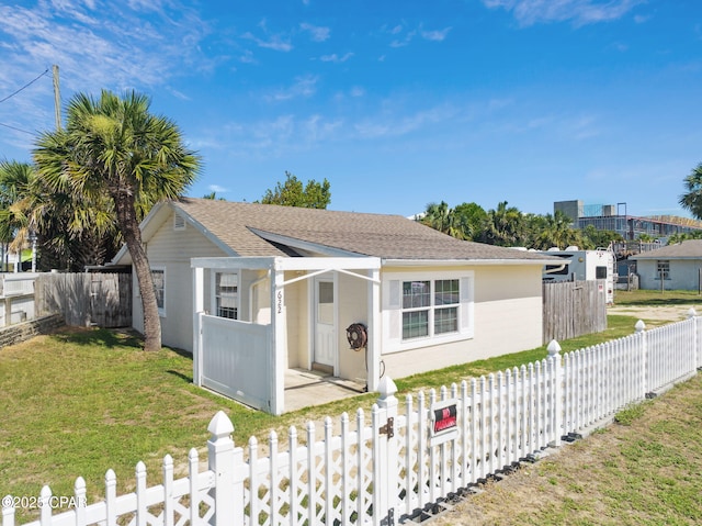 view of front of property with a fenced front yard and a front lawn