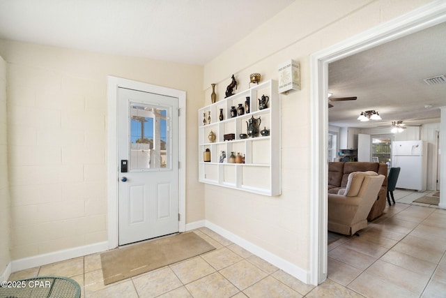 foyer featuring light tile patterned floors, visible vents, baseboards, and ceiling fan