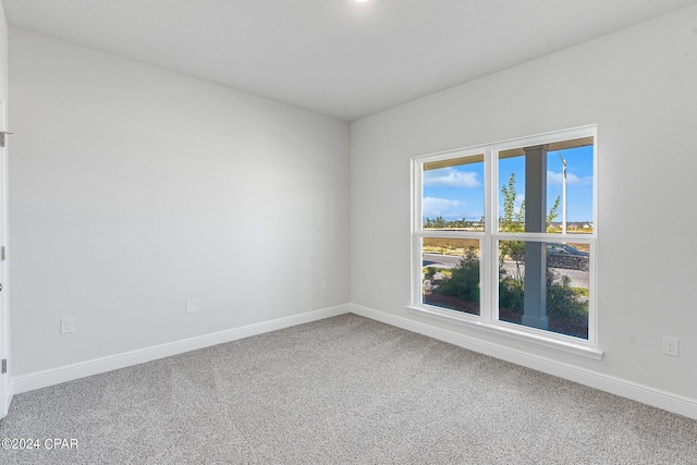 empty room with carpet floors and baseboards