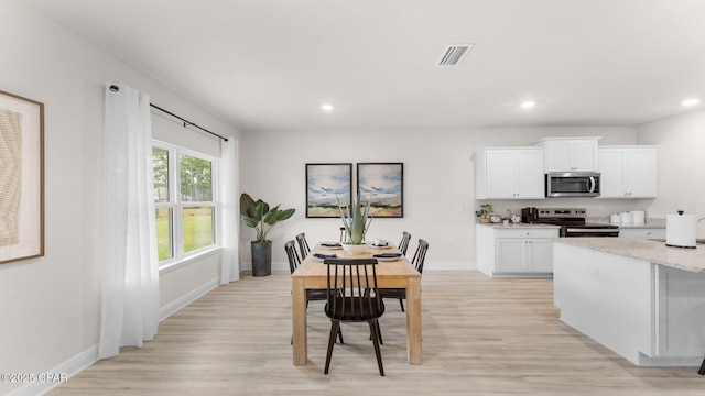 110 Crane Dr, Port St Joe, FL 32456 - dining space with light wood-style flooring, recessed lighting, and baseboards