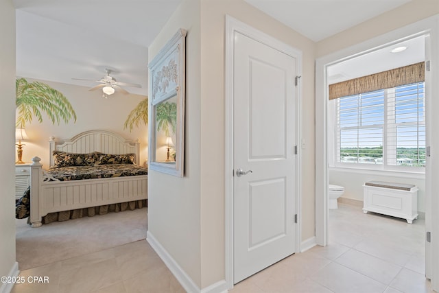 bedroom with light tile patterned floors and baseboards